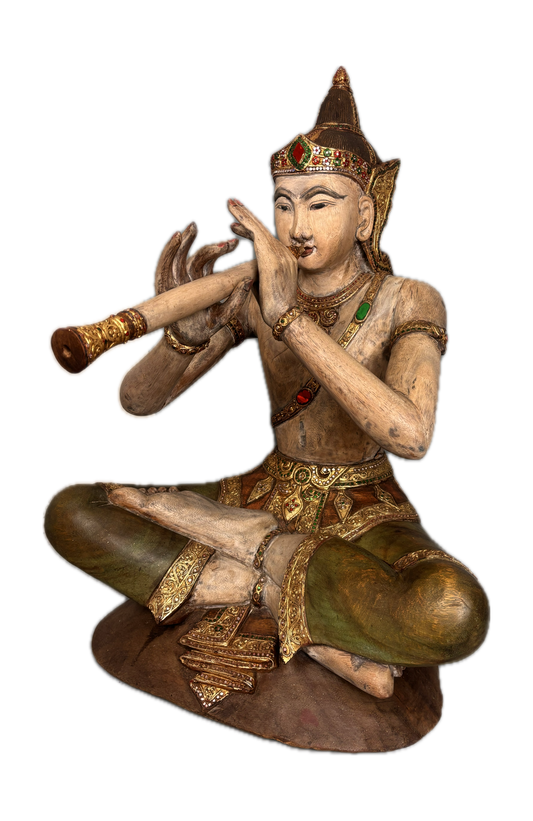 Wooden statue of a figure playing a flute on a white background