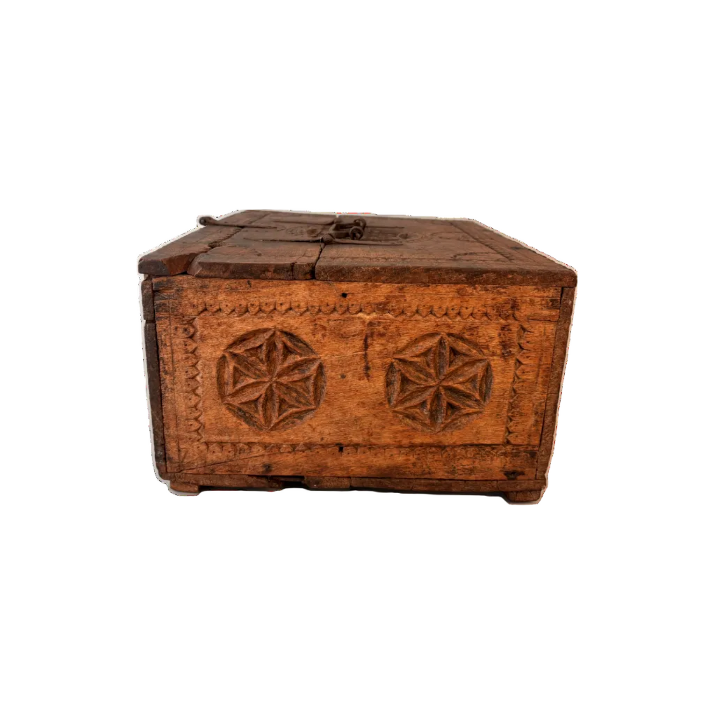 Side view of carved Swat–Kohistan wooden box showing chip-carved border and rosette motifs with aged patina.