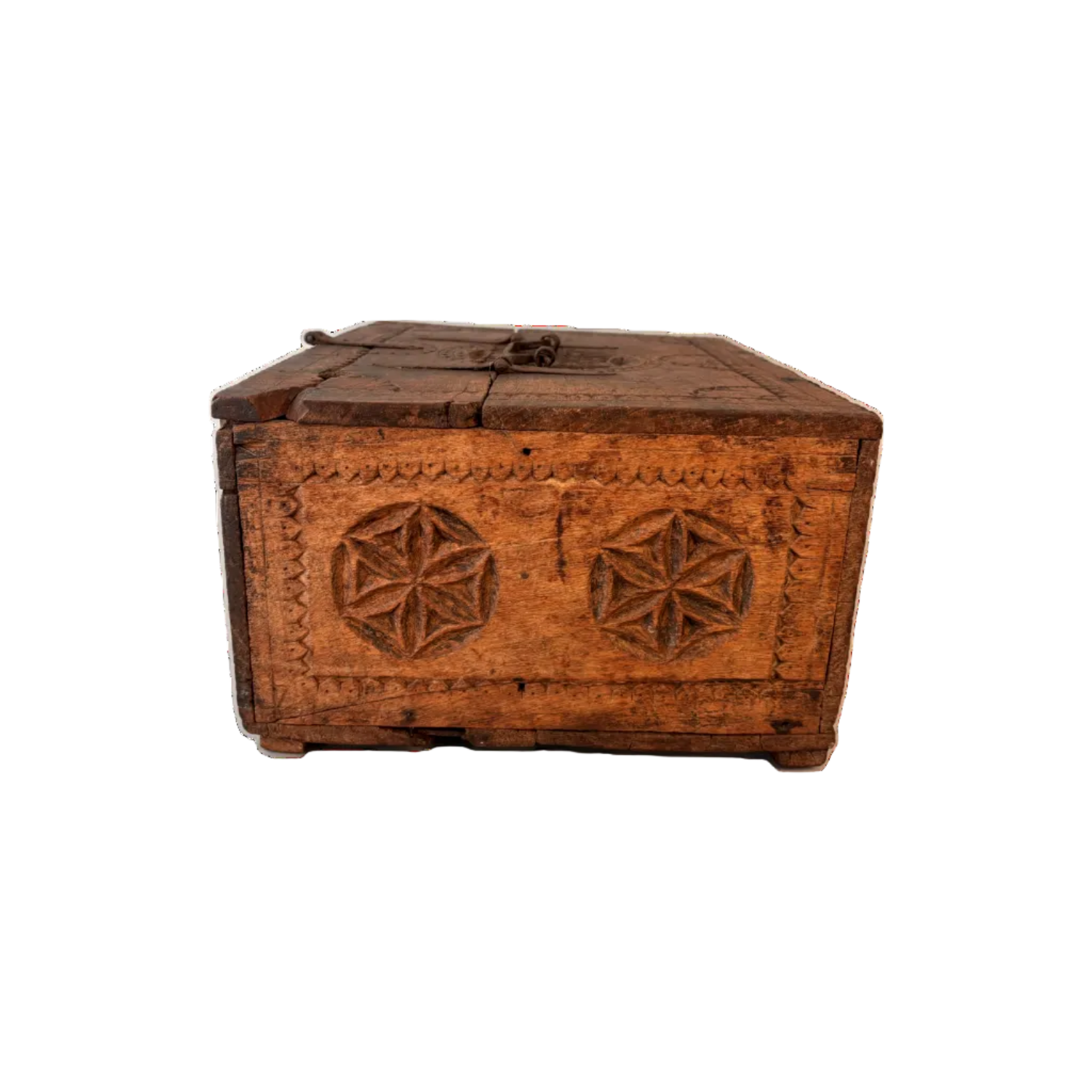 Side view of carved Swat–Kohistan wooden box showing chip-carved border and rosette motifs with aged patina.
