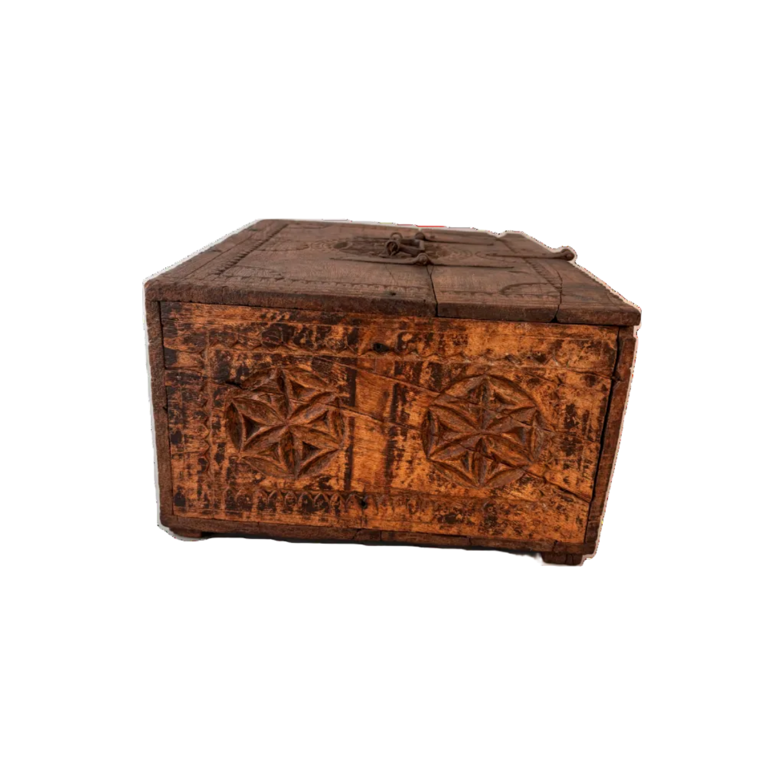 Side view of carved Swat–Kohistan wooden box showing chip-carved border and rosette motifs with aged patina