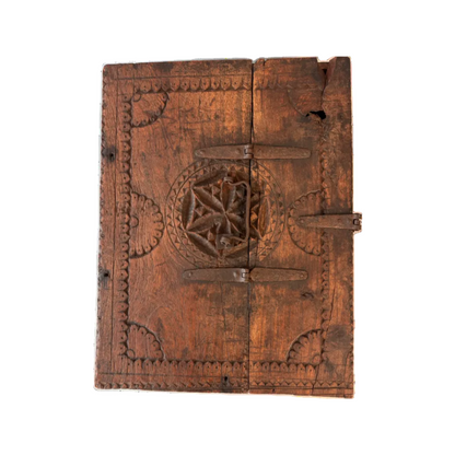 Top view of antique carved wooden dowry box with forged iron carry handle and oxidised strapwork