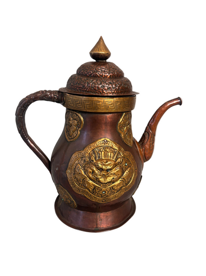 Copper and gilt-brass repoussé Sino-Tibetan style ewer with turquoise inlay and dragon mask medallion, domed lid and spout.