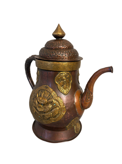 Copper and gilt-brass repoussé Sino-Tibetan style ewer with turquoise inlay and dragon mask medallion, domed lid and spout.