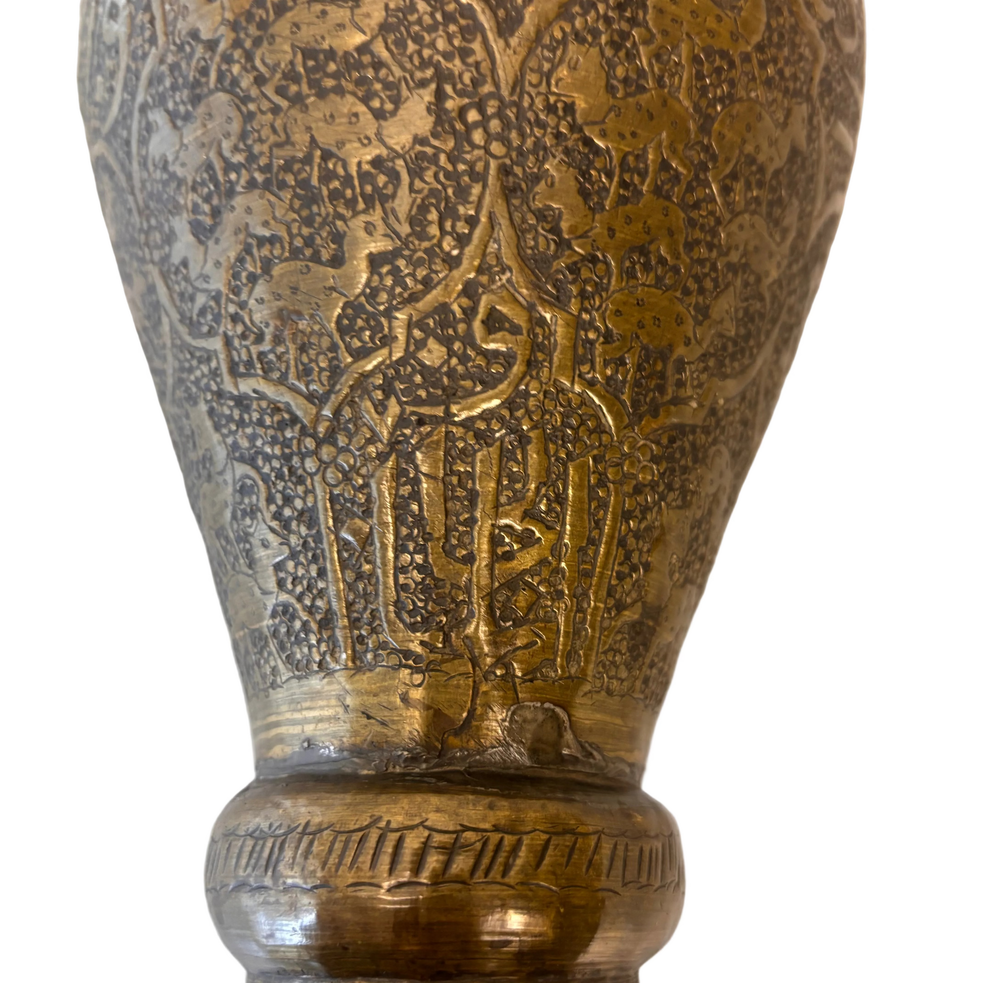 Detail of Persian brass vase showing engraved calligraphy within cartouche