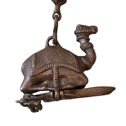 Antique Indian bronze camel oil lamp with suspended figural chain, late 19th century