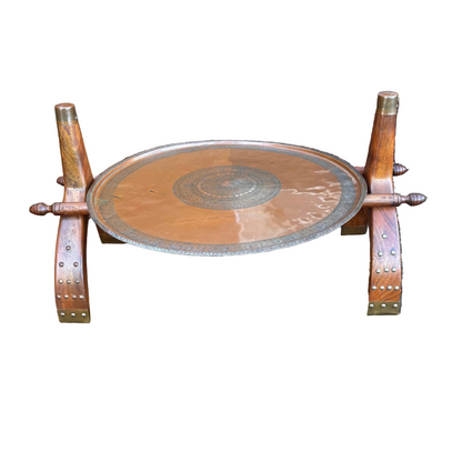 Safavid Persian engraved copper tray with calligraphic medallion on mid-century Indian camel saddle wooden stand