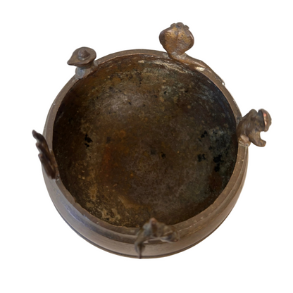 Interior of South Indian brass Thirtham Kinnam ritual vessel showing patina from use