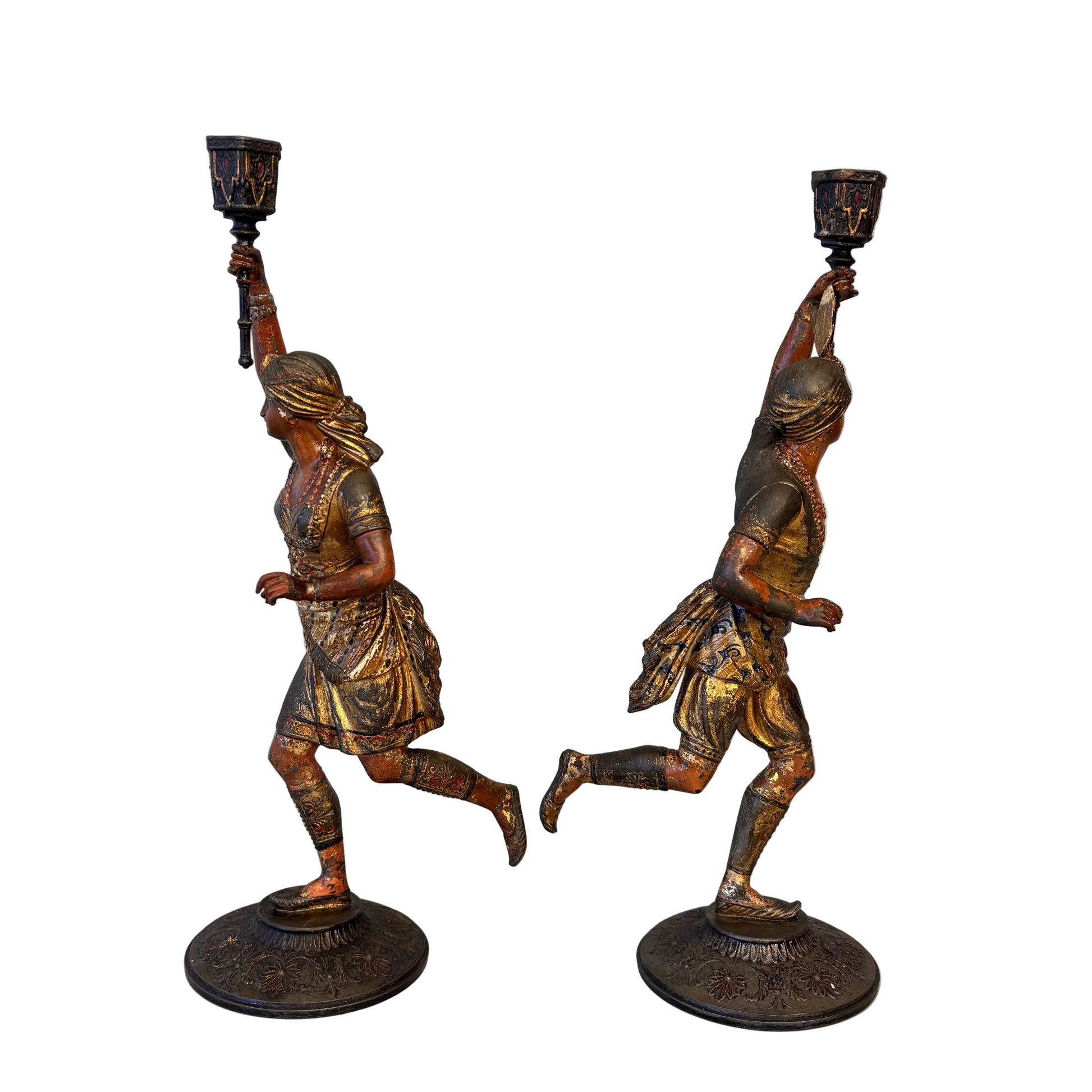 Side view of Victorian Orientalist male and female spelter candlestick figures holding raised torch sconces