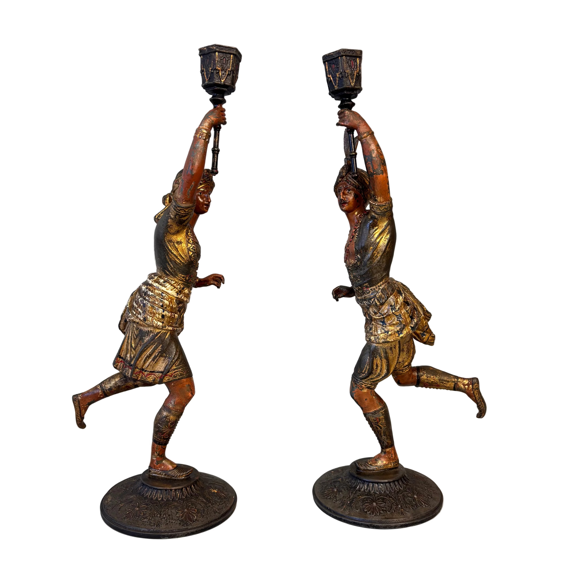 Side view of Victorian Orientalist male and female spelter candlestick figures holding raised torch sconces