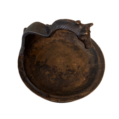 Interior of antique Indian bronze oil lamp showing soot patina