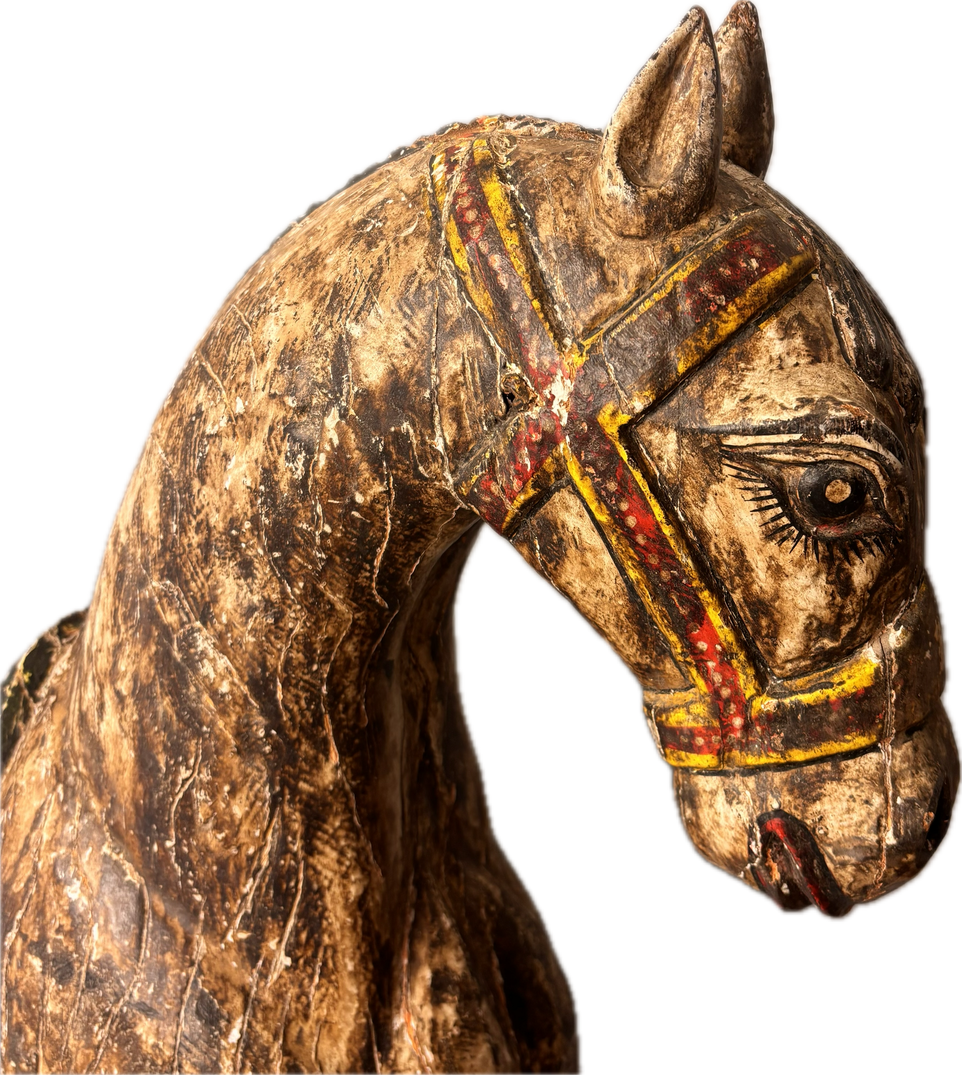 Close-up of carved horse head with painted bridle and stylised eyes