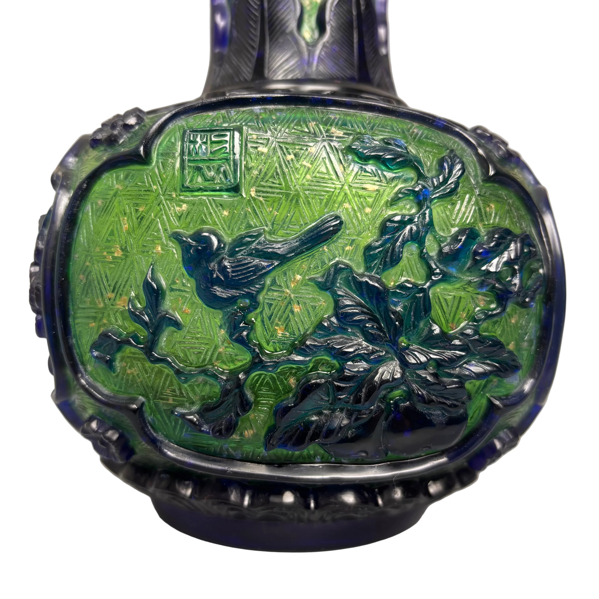 Close-up of bird and floral carving on overlay glass