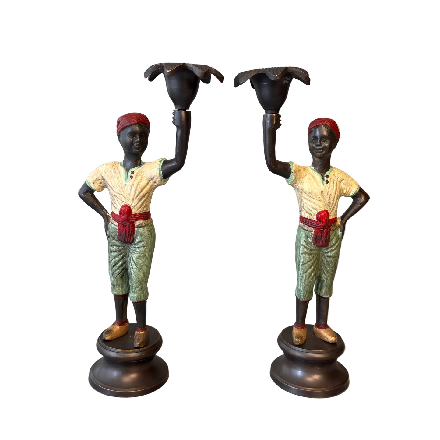 Pair of early 20th century polychrome figural candlesticks with red turbans and flower-form candle cups on circular bases
