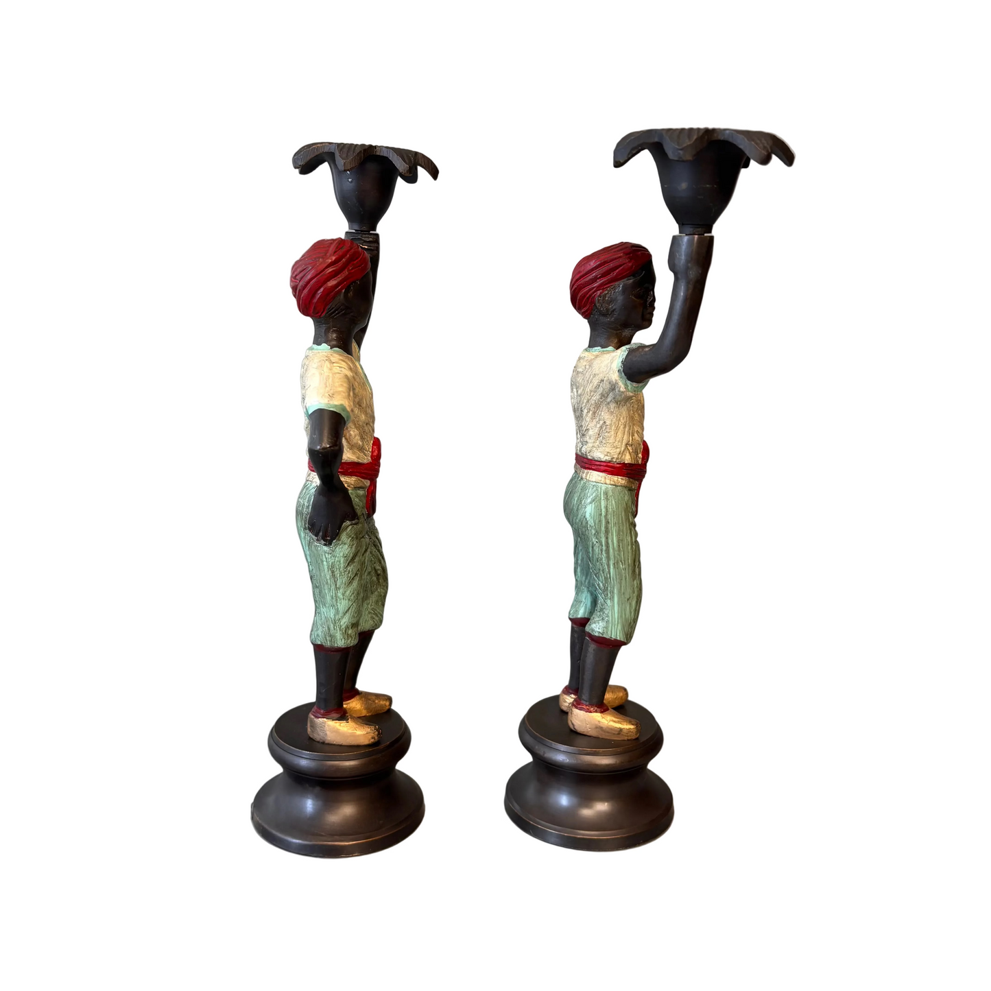 Pair of early 20th century polychrome figural candlesticks with red turbans and flower-form candle cups on circular bases