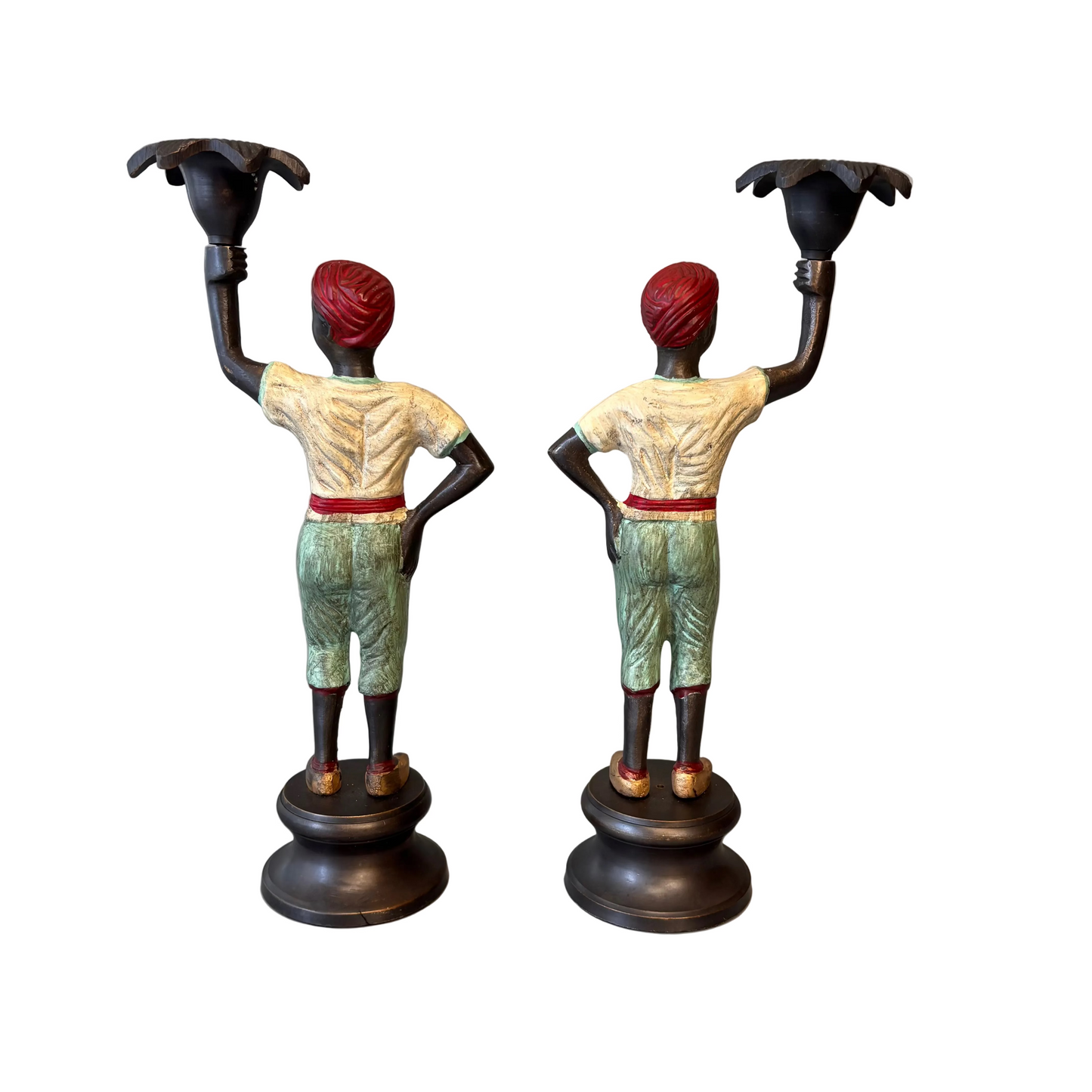 Pair of early 20th century polychrome figural candlesticks with red turbans and flower-form candle cups on circular bases