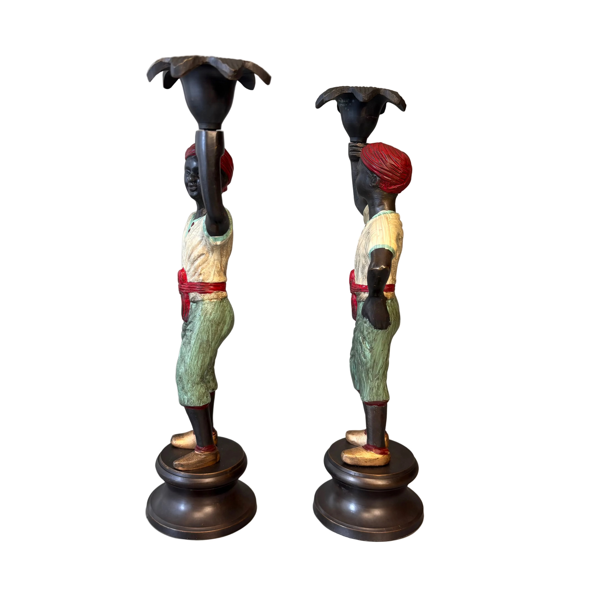Pair of early 20th century polychrome figural candlesticks with red turbans and flower-form candle cups on circular bases
