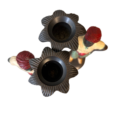 Pair of early 20th century polychrome figural candlesticks with red turbans and flower-form candle cups on circular bases