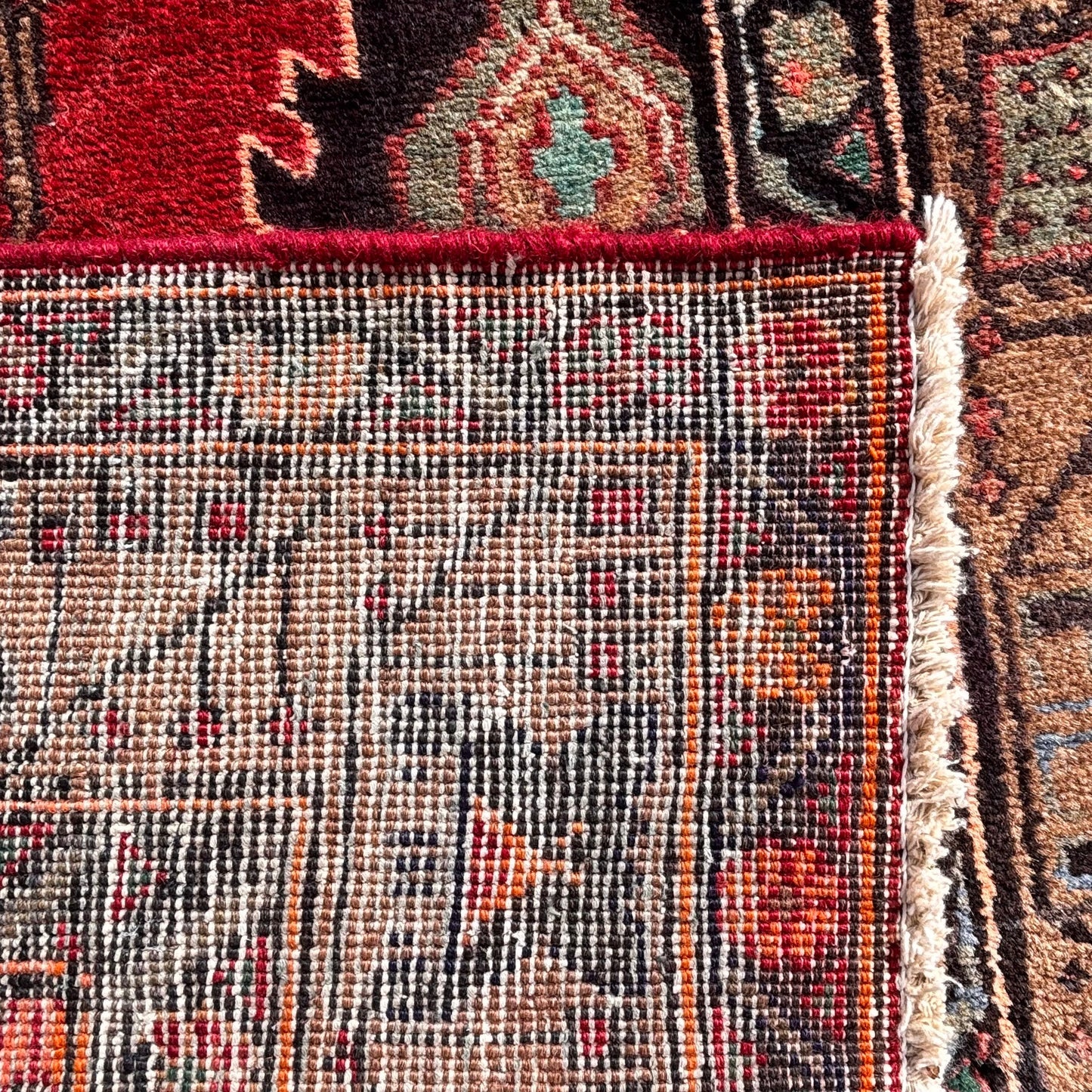 Reverse of hand knotted Persian rug showing weave structure