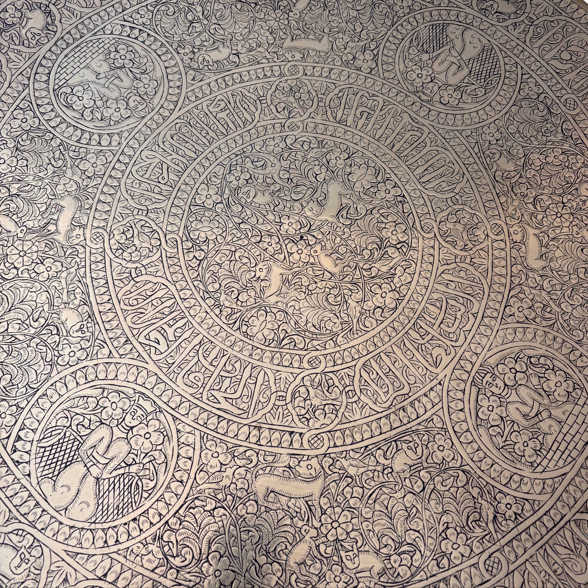 Central medallion with animals on Persian brass tray with detailed engraving