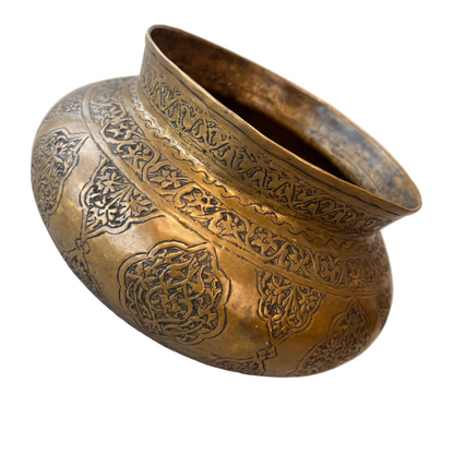 Central Asian brass bowl exterior showing alternating floral cartouche engraving