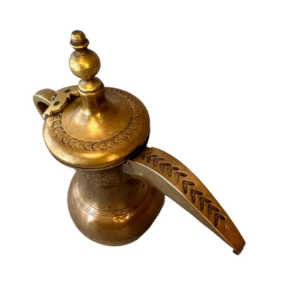 Close-up of spout engraving and hinge mechanism on Arabic dallah