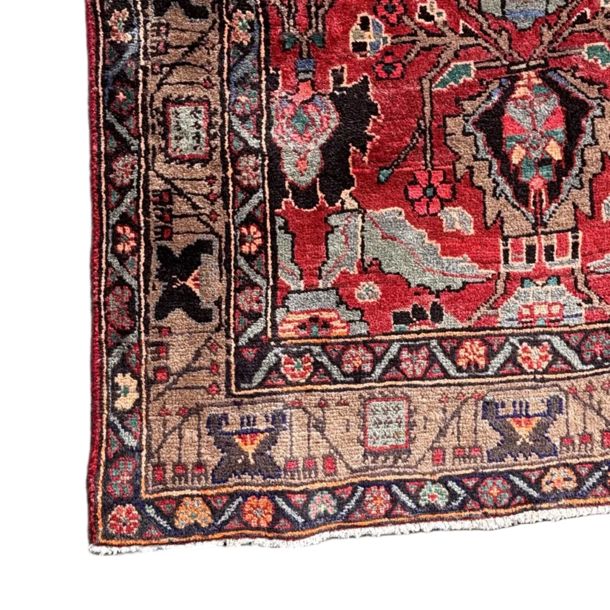 Close up of central medallion and floral motifs on red ground