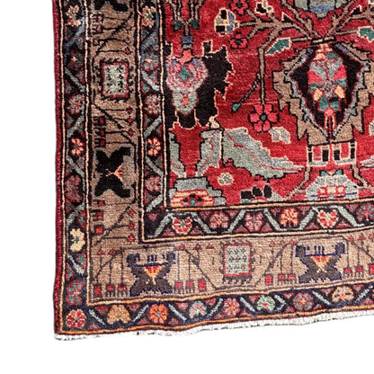 Close up of central medallion and floral motifs on red ground
