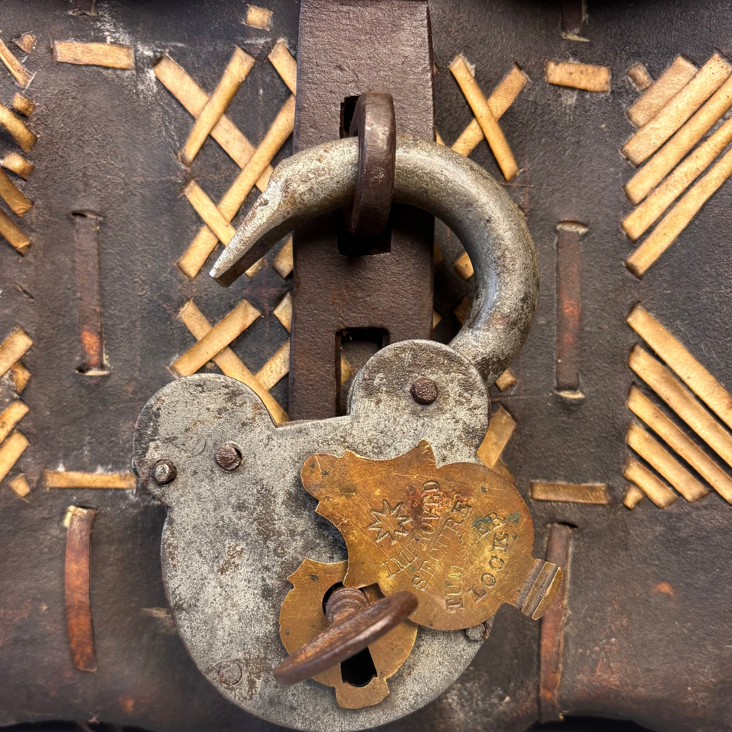 Close-up of padlock on petaca hide chest