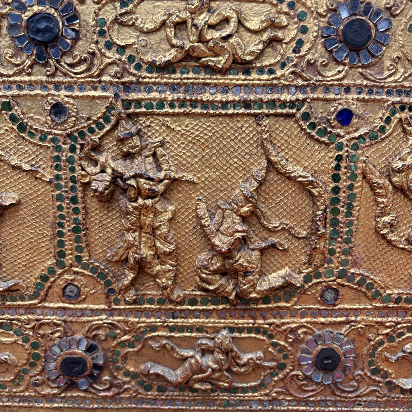 Close up view of narrative relief panels and thayo work.