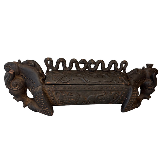 Indonesian carved wooden betel container with horned animal terminals