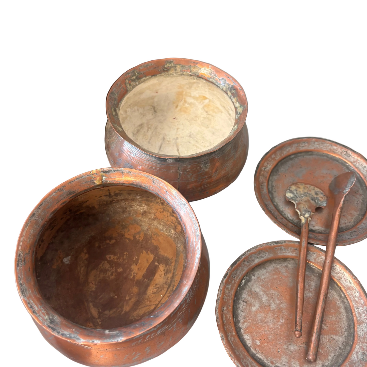 Close-up of internal copper pots with wear and patina