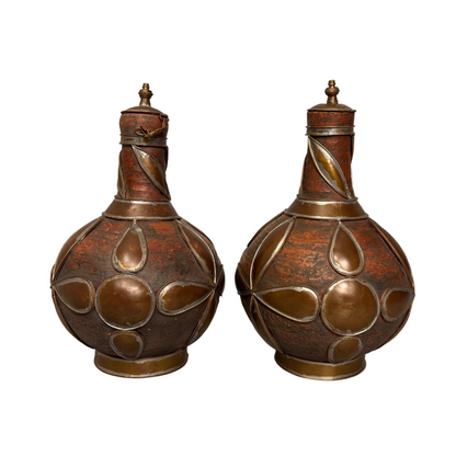 Rear view Moroccan qirba form pottery vessels with metal decoration