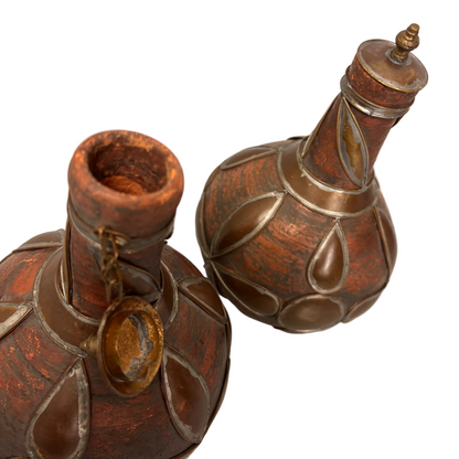 Open neck detail showing red earthenware interior and stopper chain