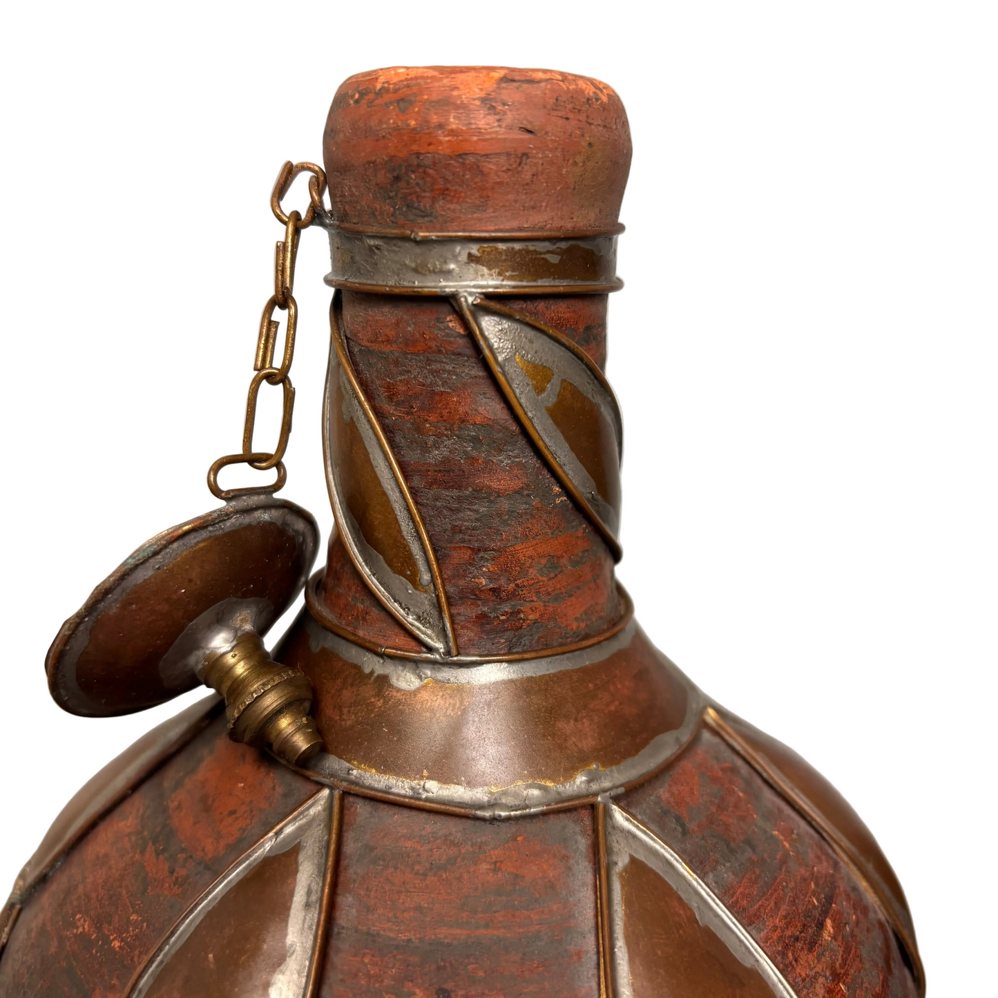 Close-up copper petal motif over red earthenware surface