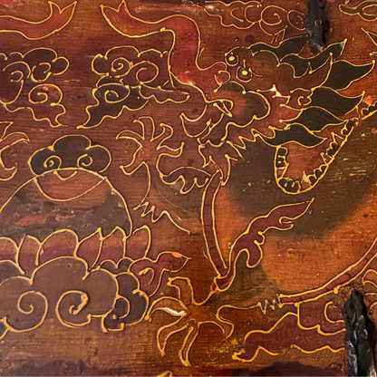 Close-up of engraved elephant and pigment decoration on antique trunk