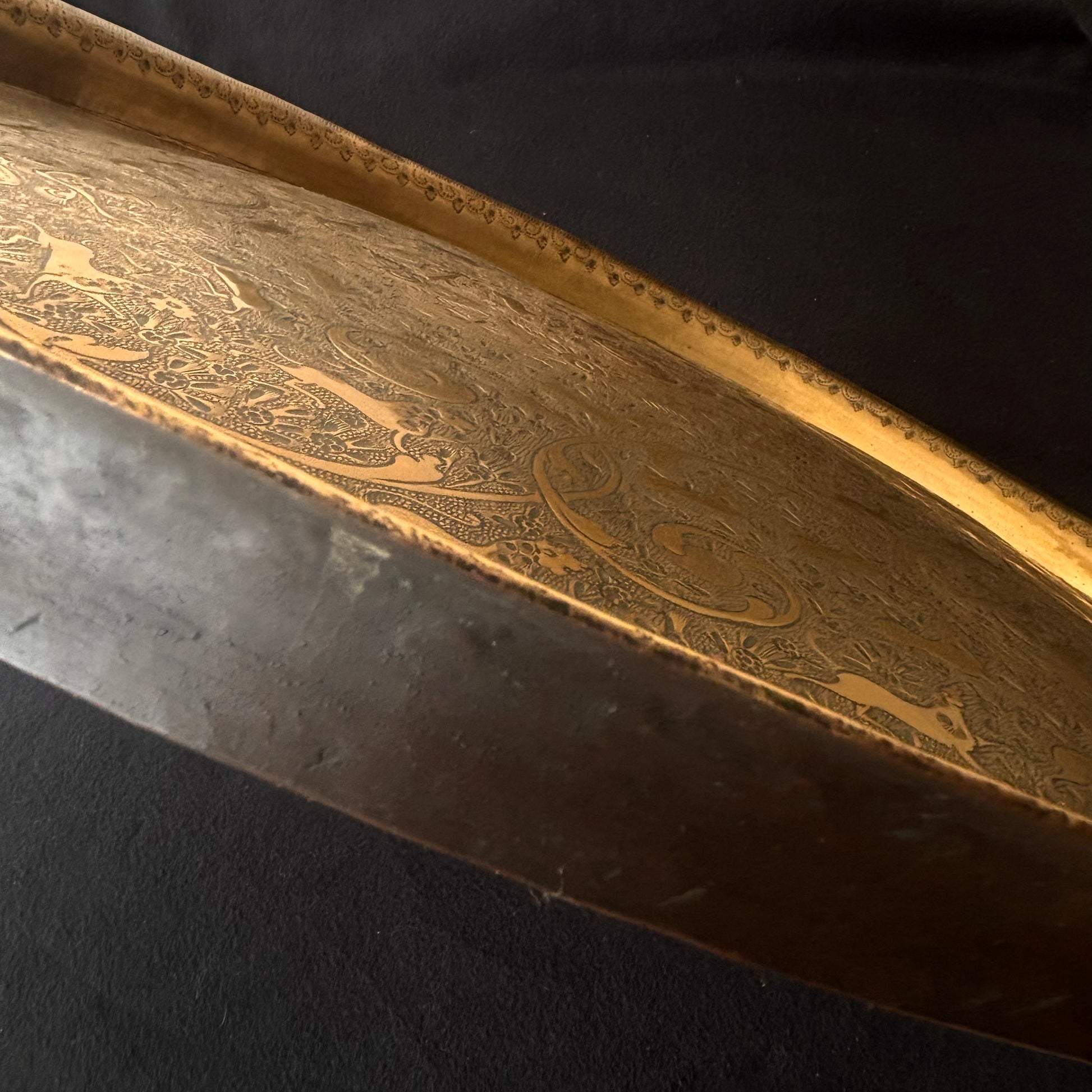 Side profile showing domed form of antique Kashmiri brass tray