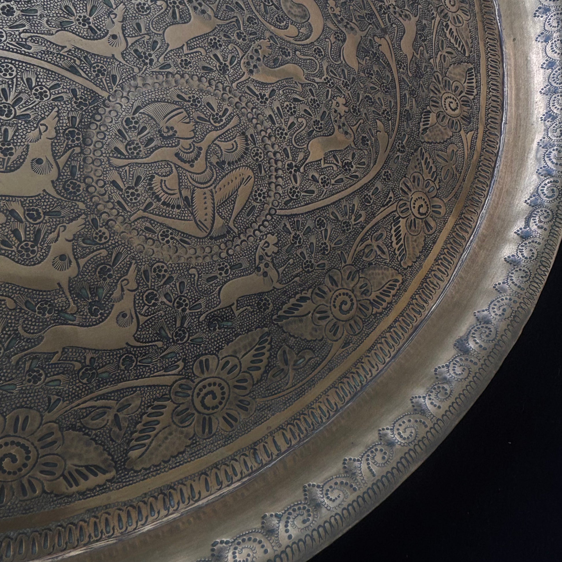 Close-up of hand engraved floral ornament on Indo Persian brass tray