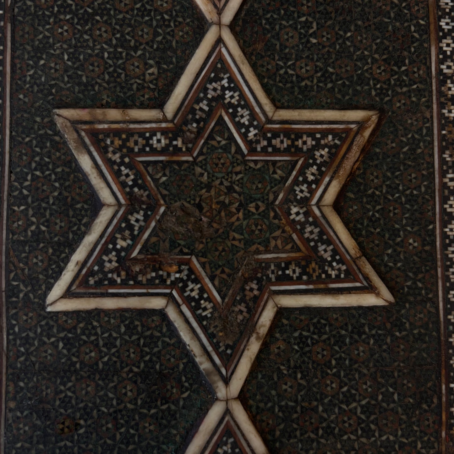 Close-up of reverse star motif with historic wear and losses