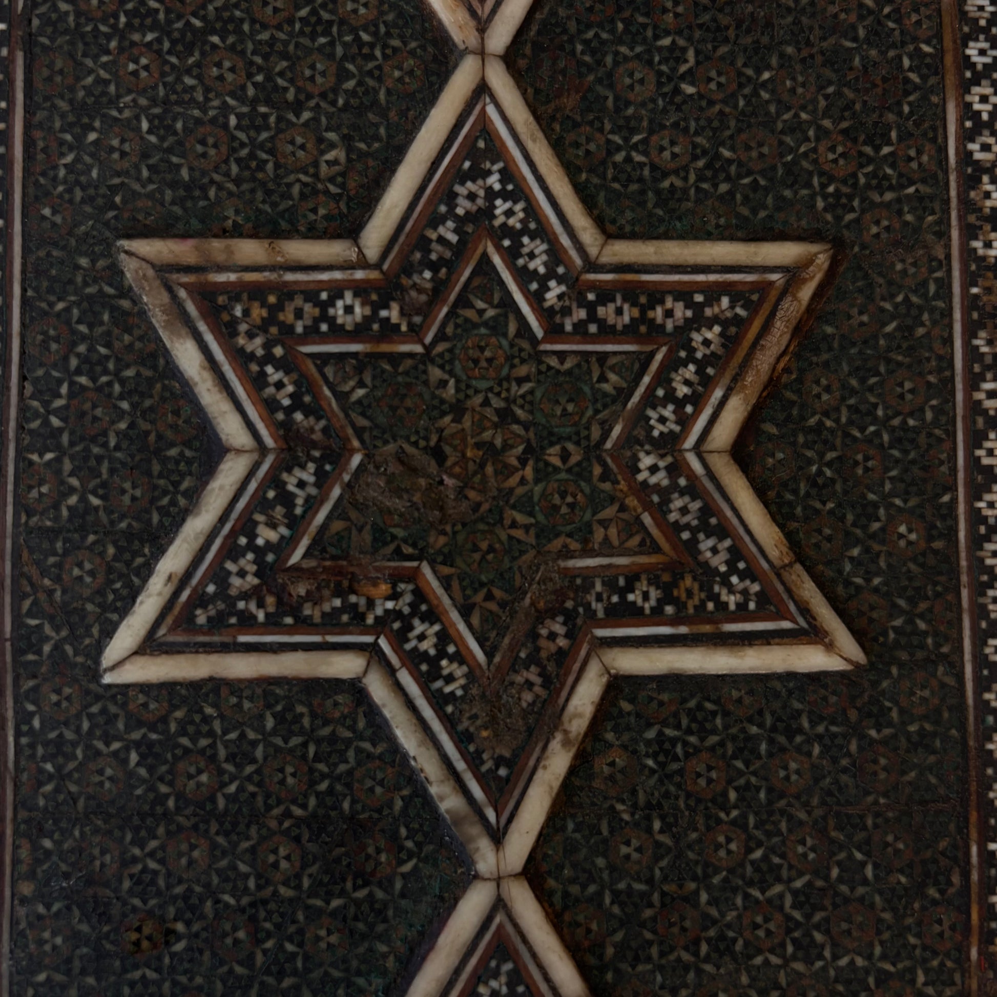Close-up of reverse star motif with historic wear and losses
