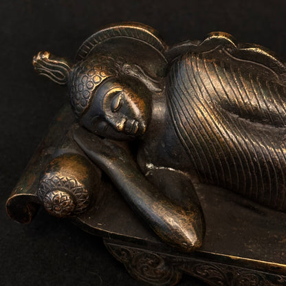 Close-up of Buddha head resting on cylindrical cushion